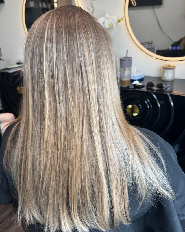 After: bright, blended blonde highlights, smooth and straight