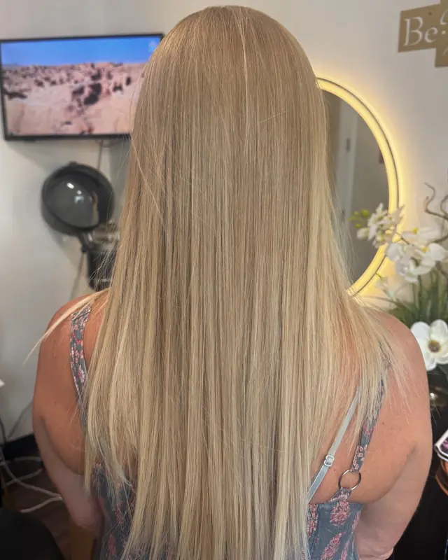 After: long, smooth, glossy blonde with a soft, deeper root