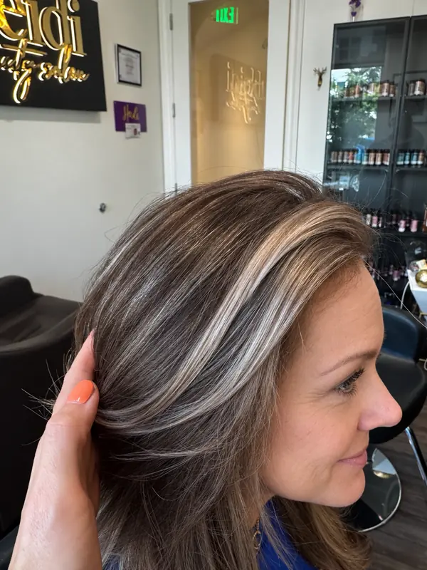 Bright, face-framing highlights on brunette hair