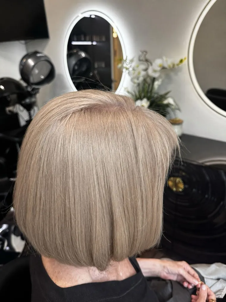Sleek blonde bob cut and style at Hair by Heidi